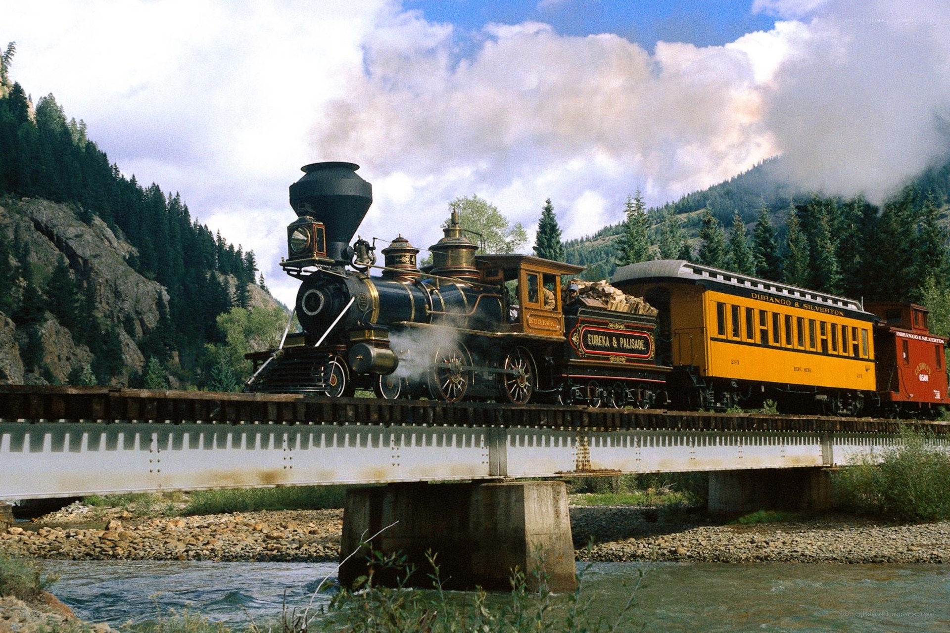 Steam train crossing a bridge