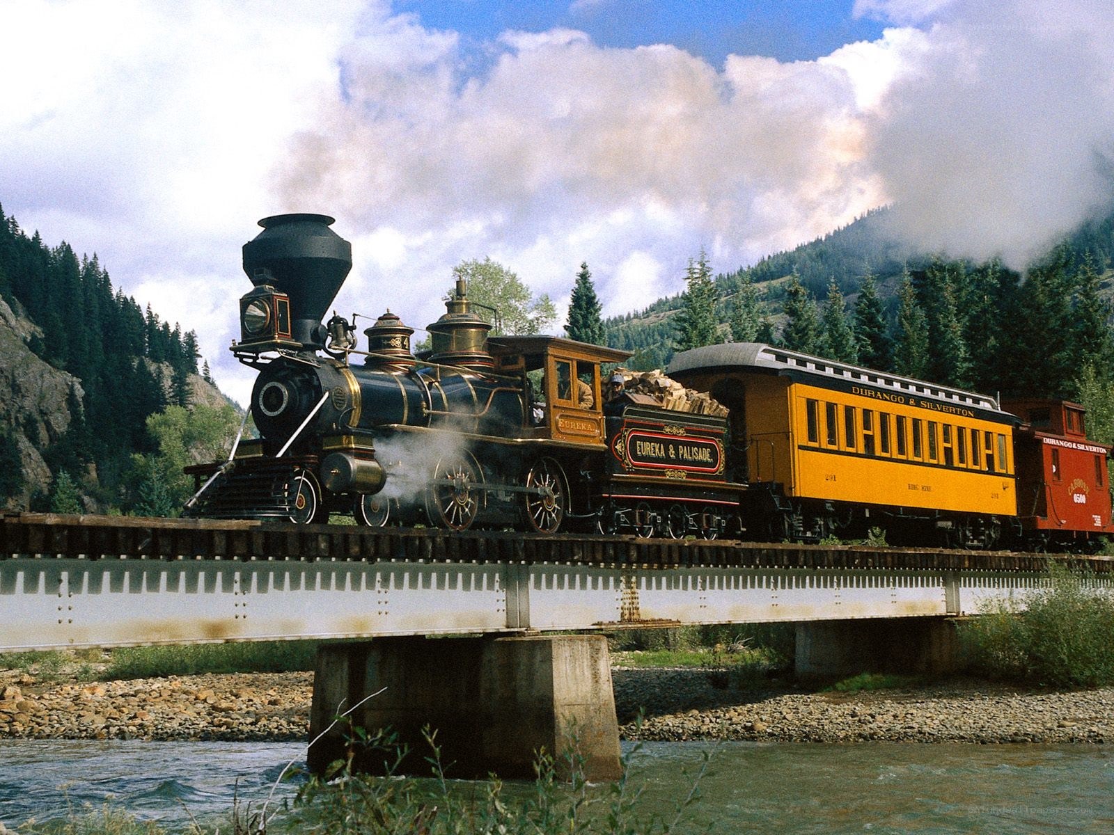 Steam train crossing a bridge
