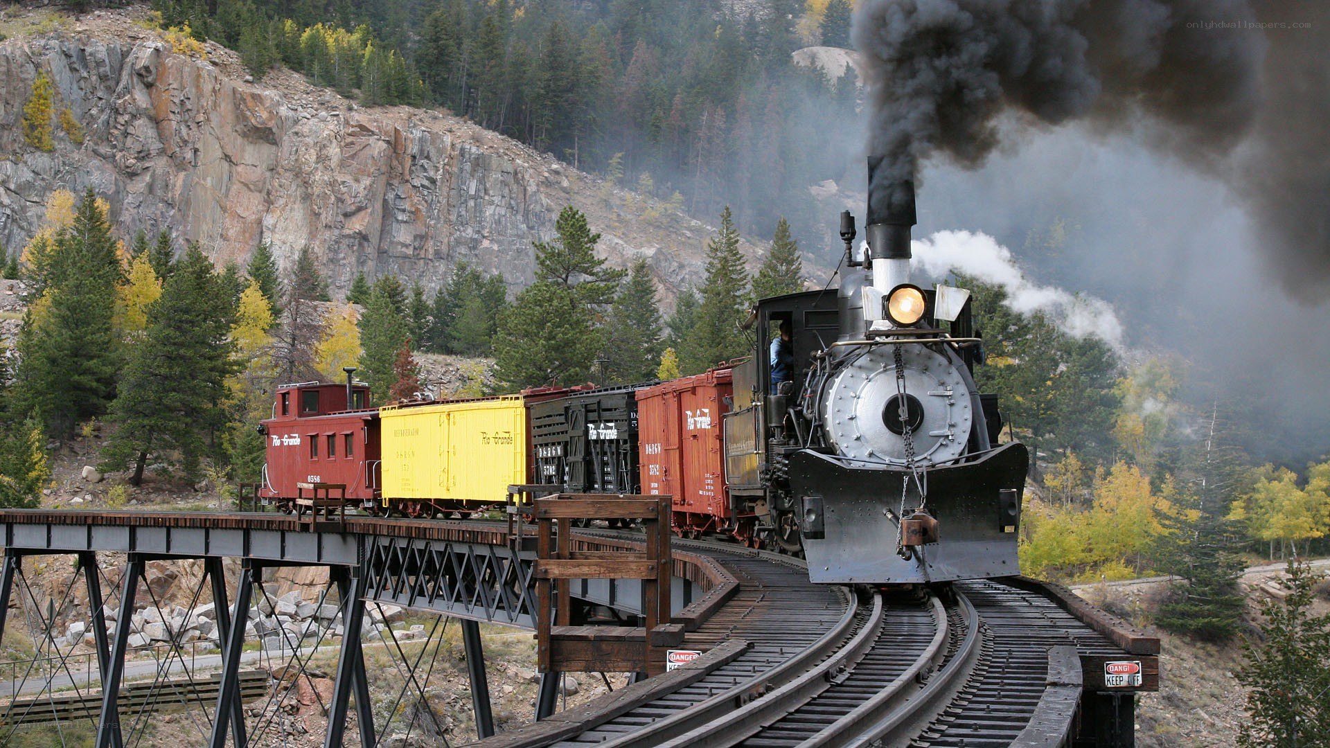 Steam train crossing a bridge