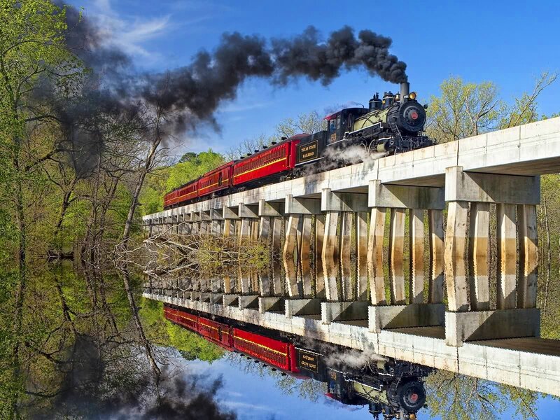 Steam train crossing a bridge