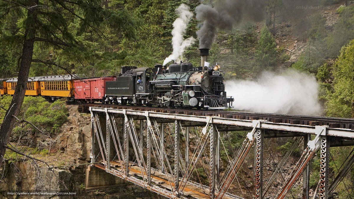 Steam train crossing a bridge