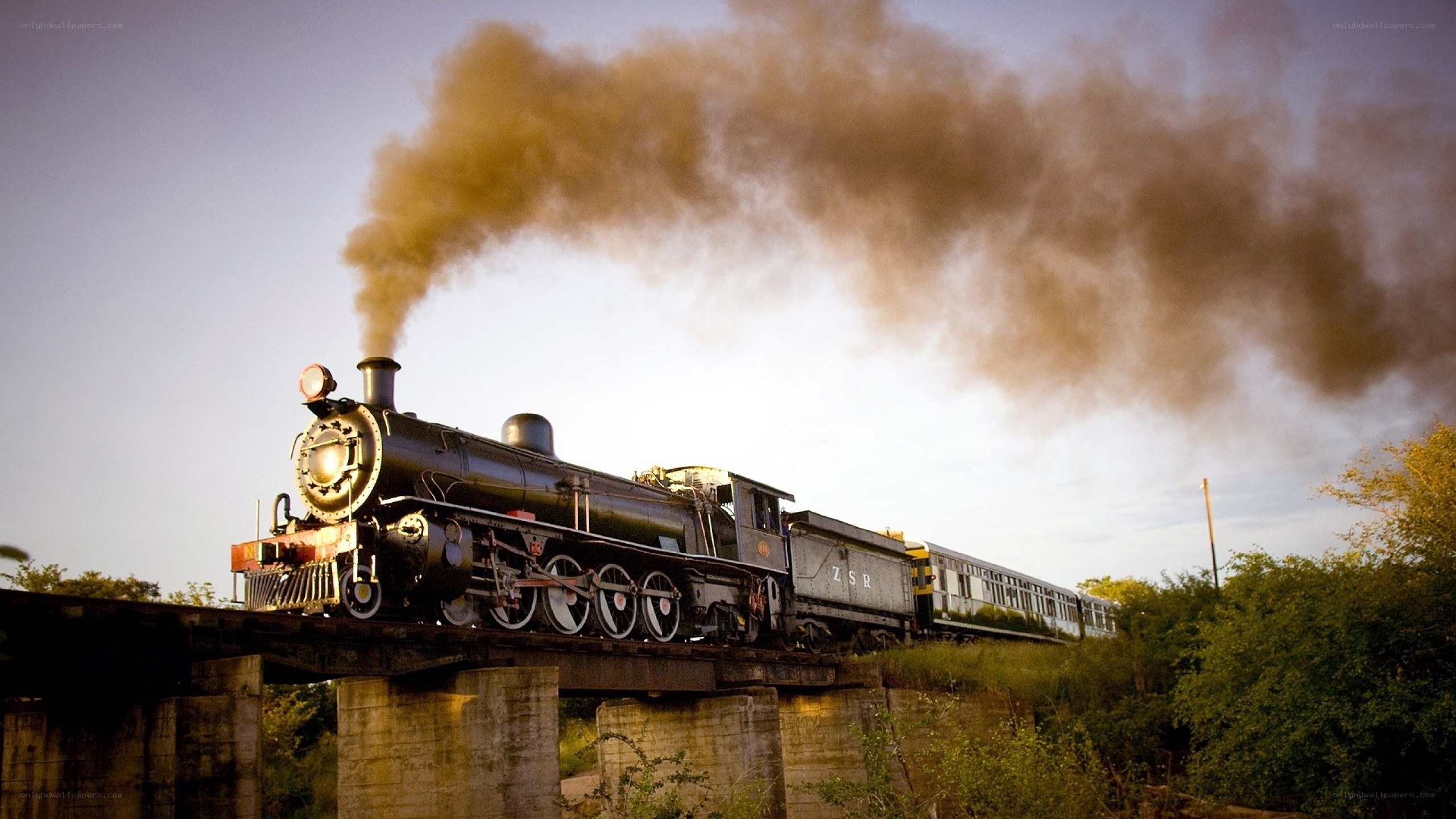 Steam train crossing a bridge