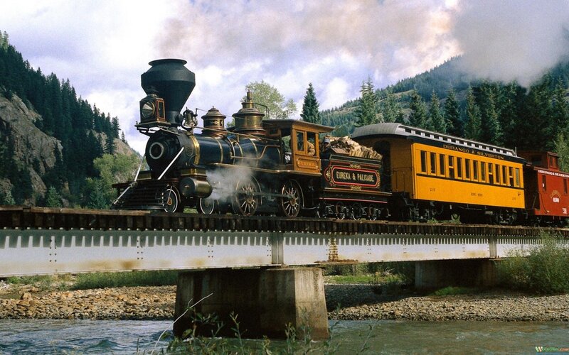 Steam train crossing a bridge