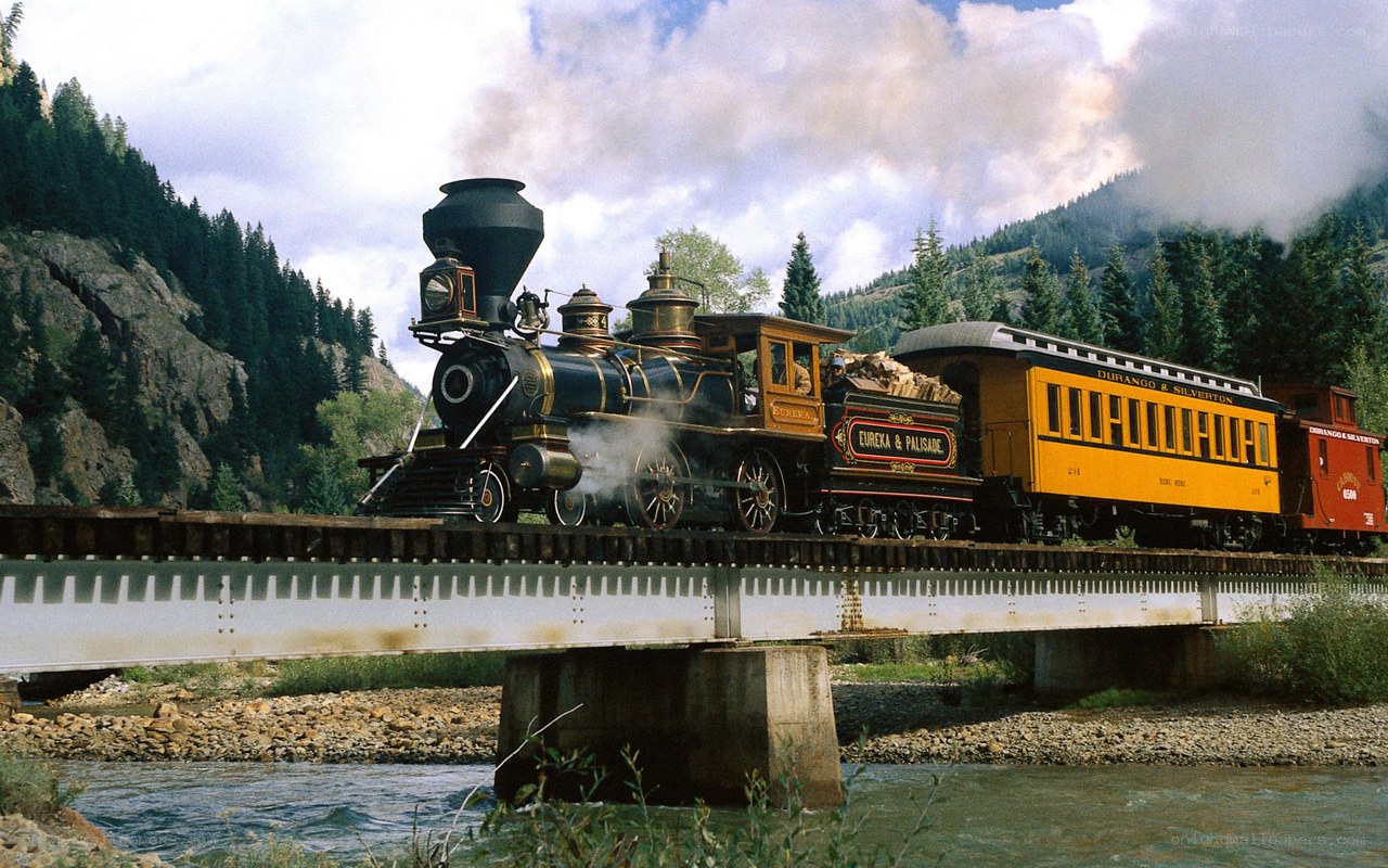 Steam train crossing a bridge