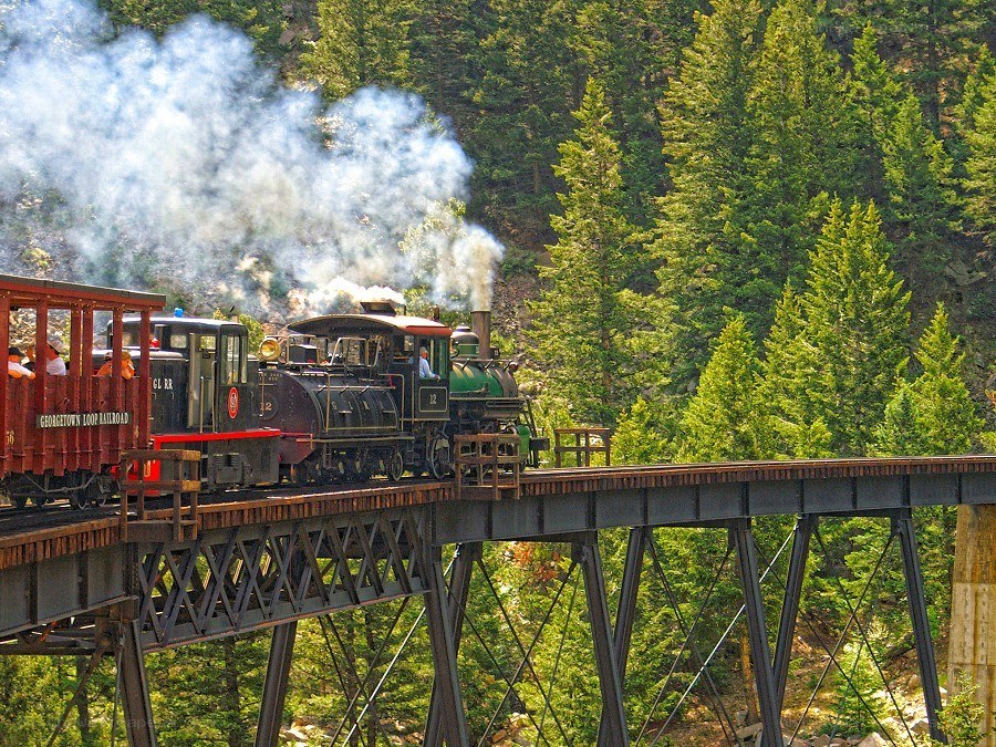 Steam train crossing a bridge