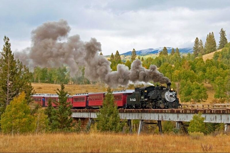 Steam train crossing a bridge