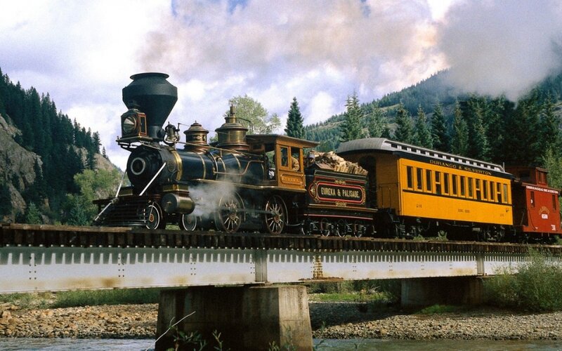 Steam train crossing a bridge