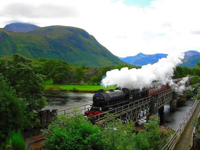 Steam train crossing a bridge