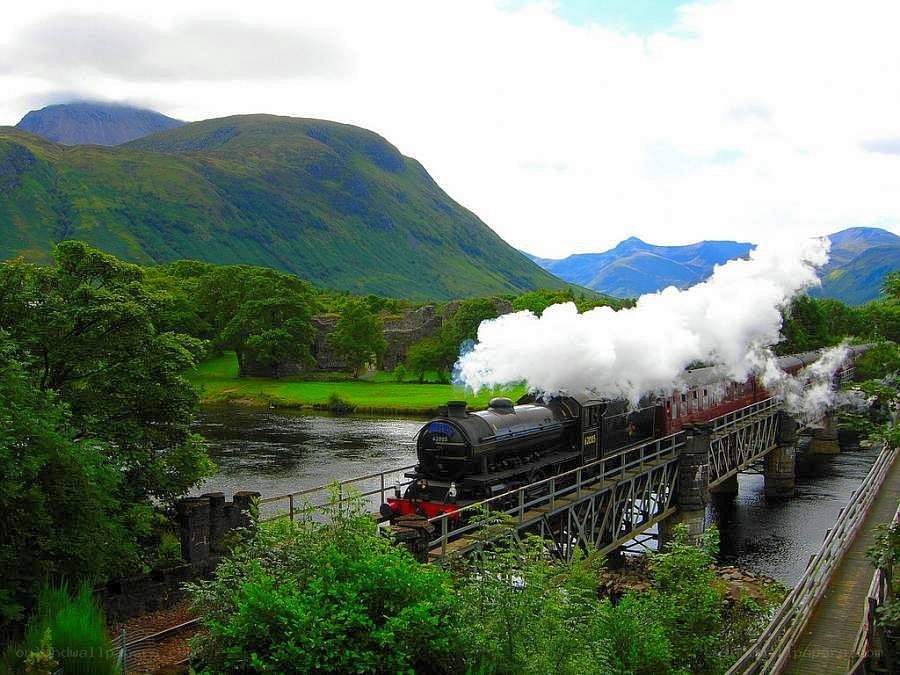 Steam train crossing a bridge