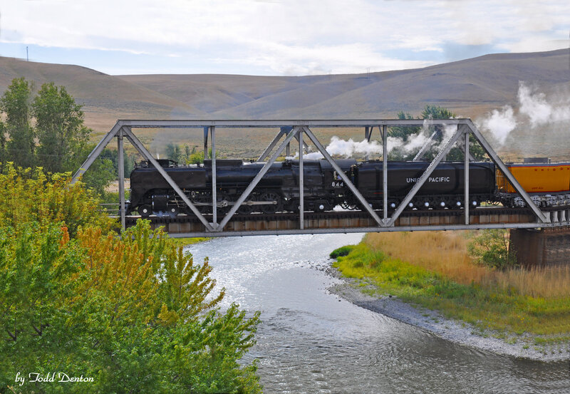Steam train crossing a bridge