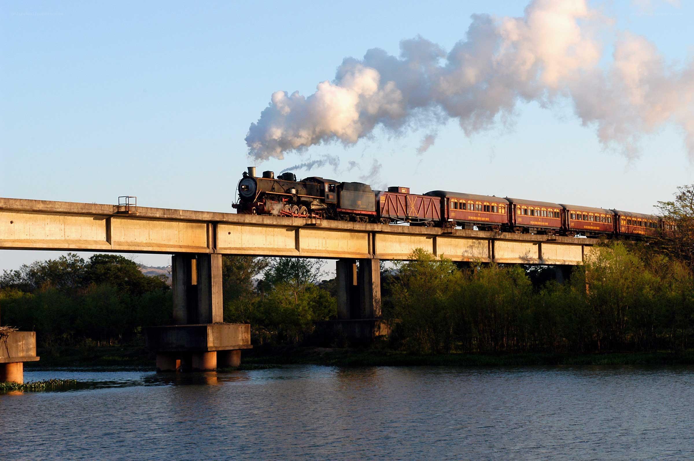 Steam train crossing a bridge