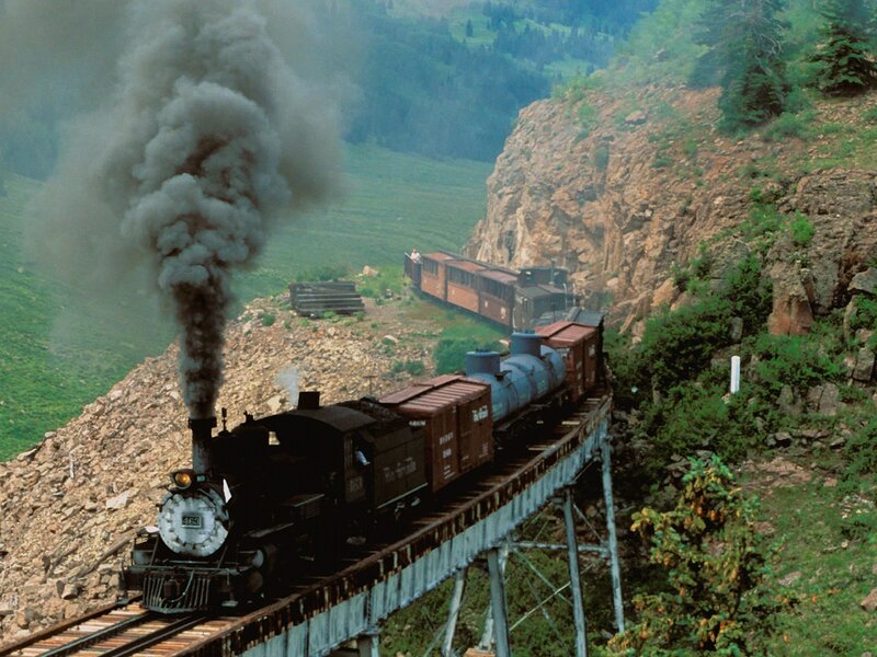 Steam train crossing a bridge
