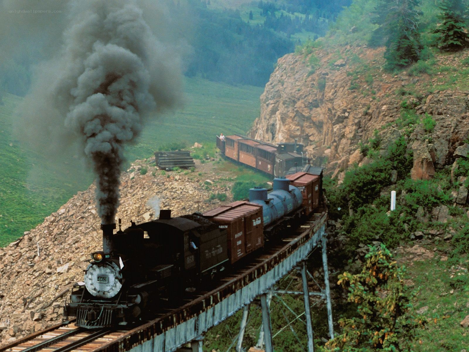 Steam train crossing a bridge
