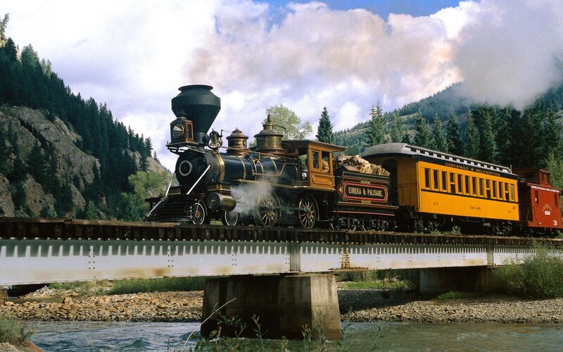 Steam train crossing a bridge