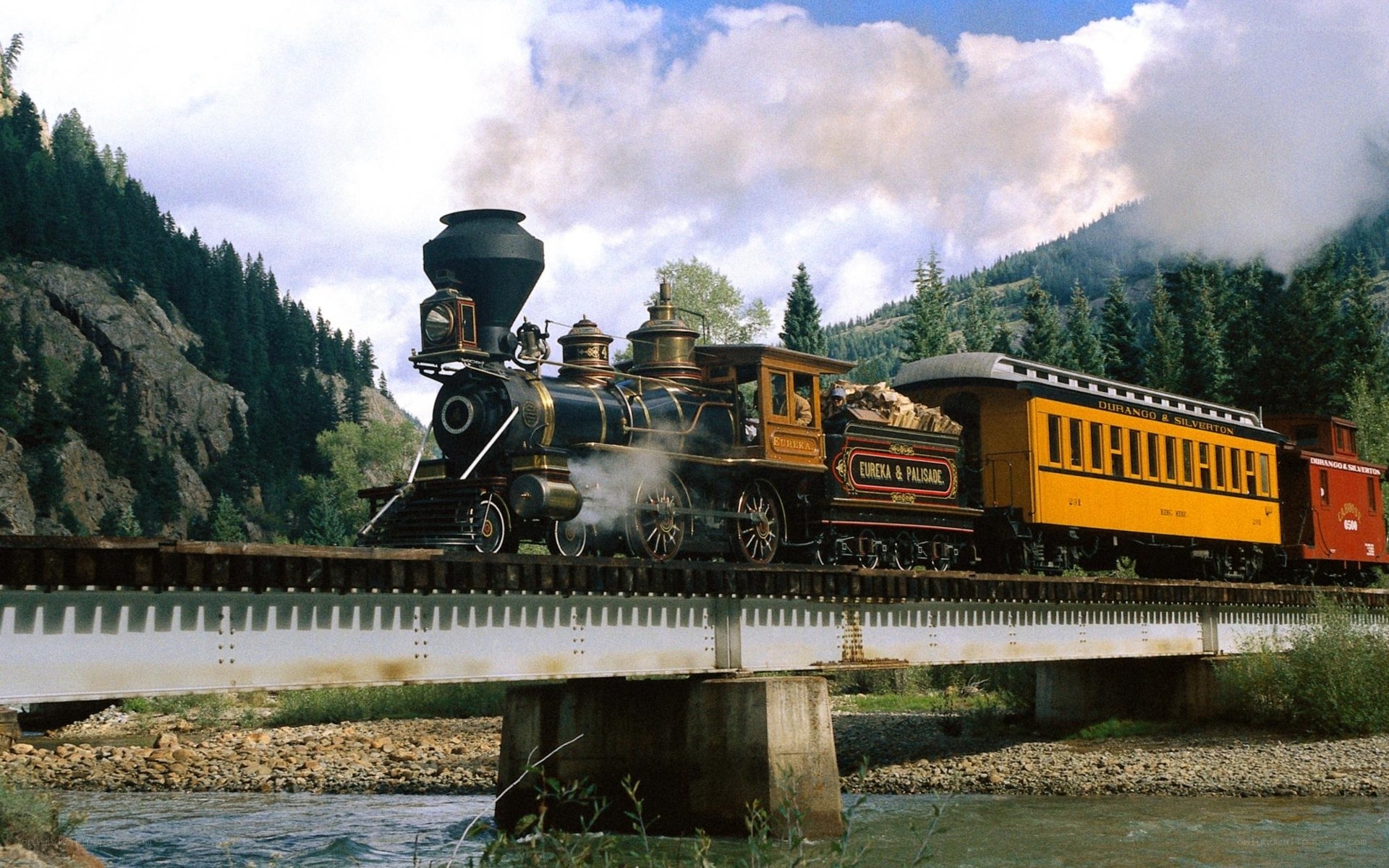Steam train crossing a bridge