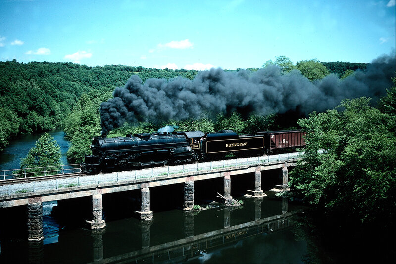 Steam train crossing a bridge