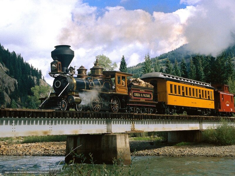 Steam train crossing a bridge