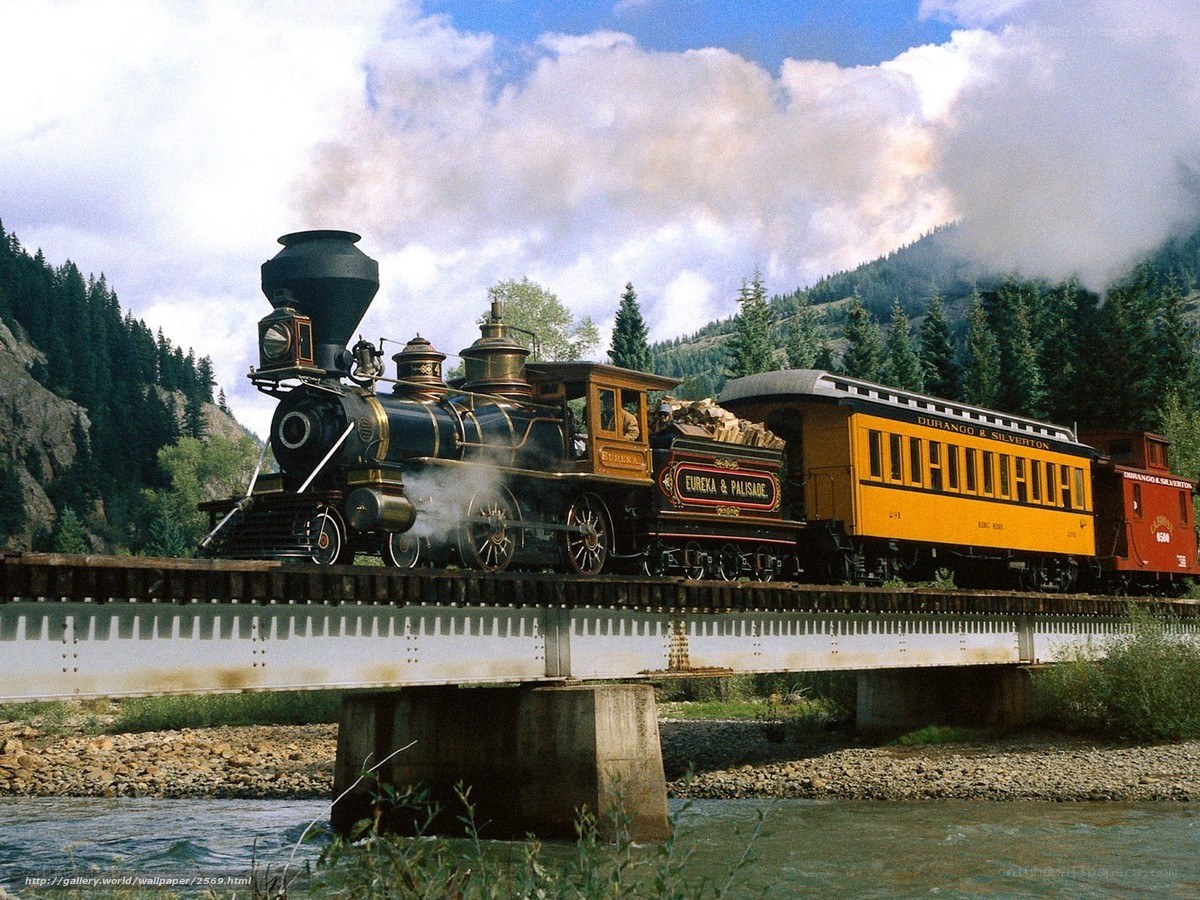 Steam train crossing a bridge