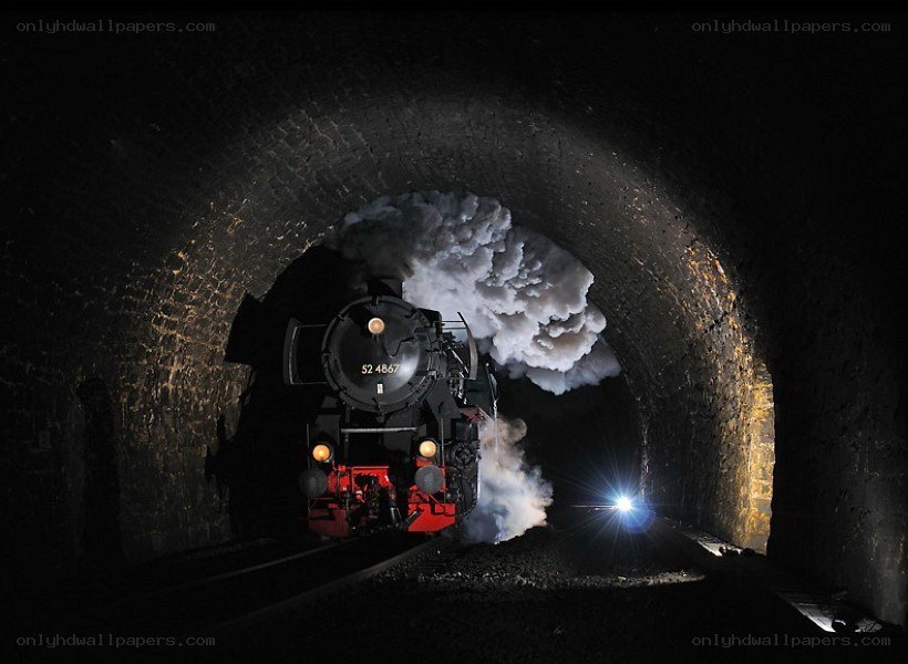 Steam train in a dark tunnel