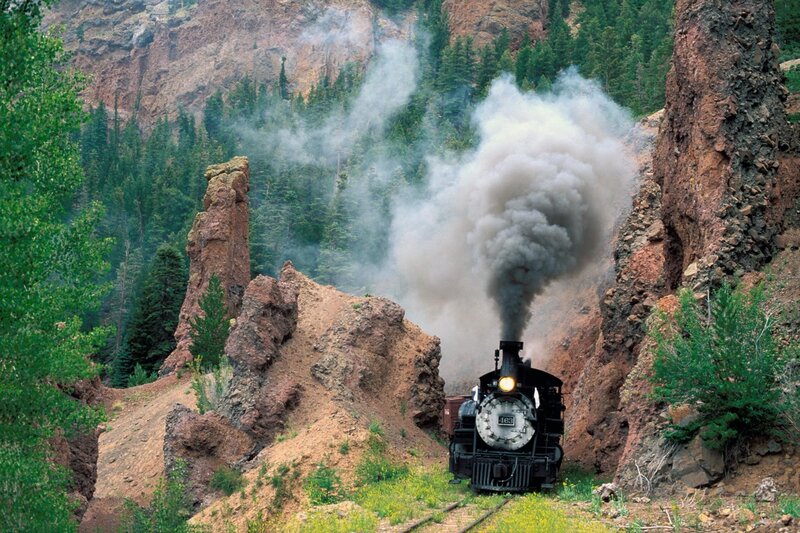 Steam train in a rocky canyon