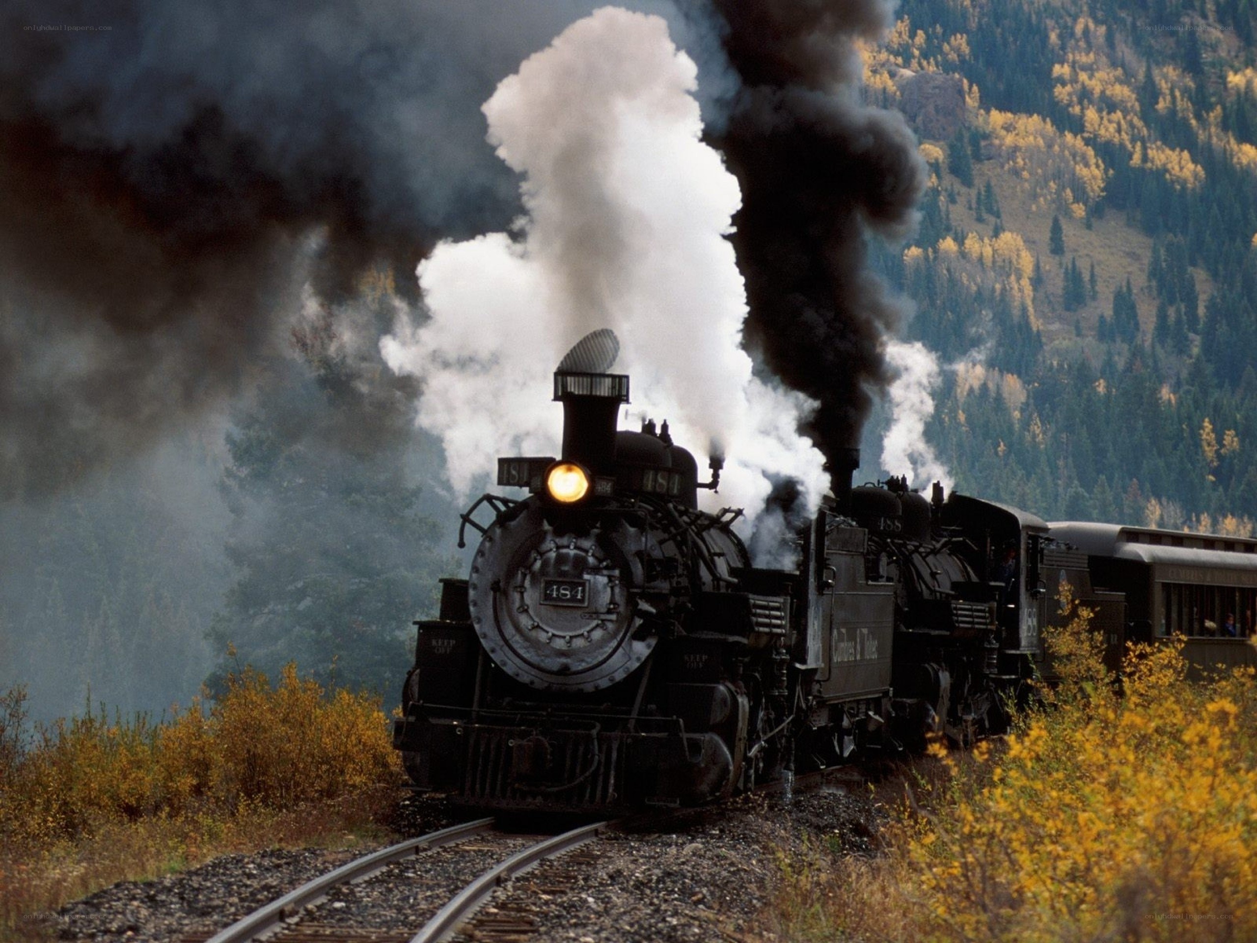 Steam train in autumn mountains