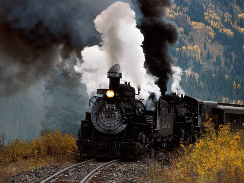 Steam train in autumn mountains