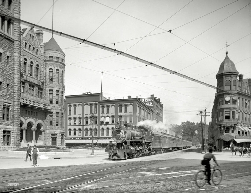 Steam train in city street