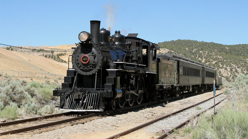 Steam train in desert landscape