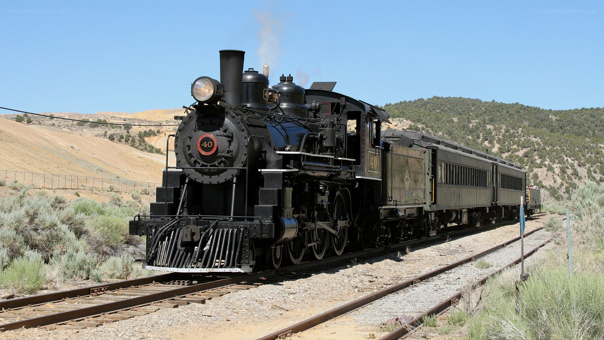 Steam train in desert landscape