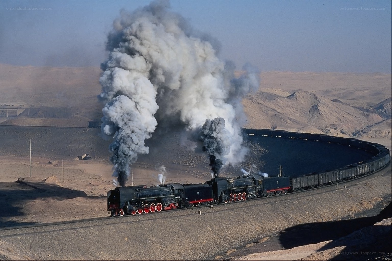 Steam train in desert landscape