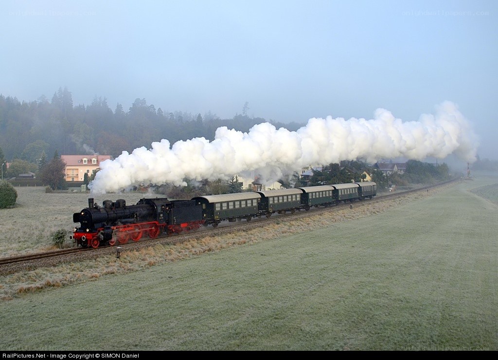 Steam train in foggy landscape