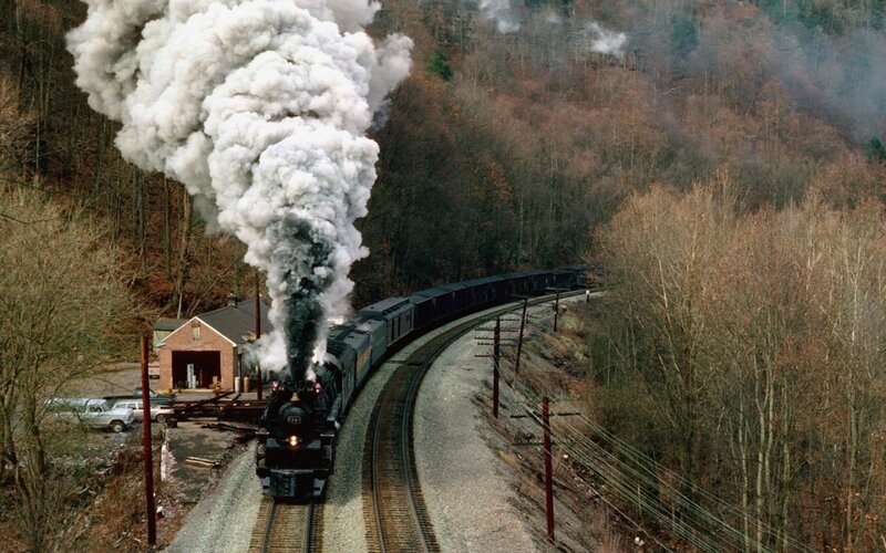 Steam train in forested valley