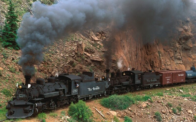 Steam train in mountain canyon