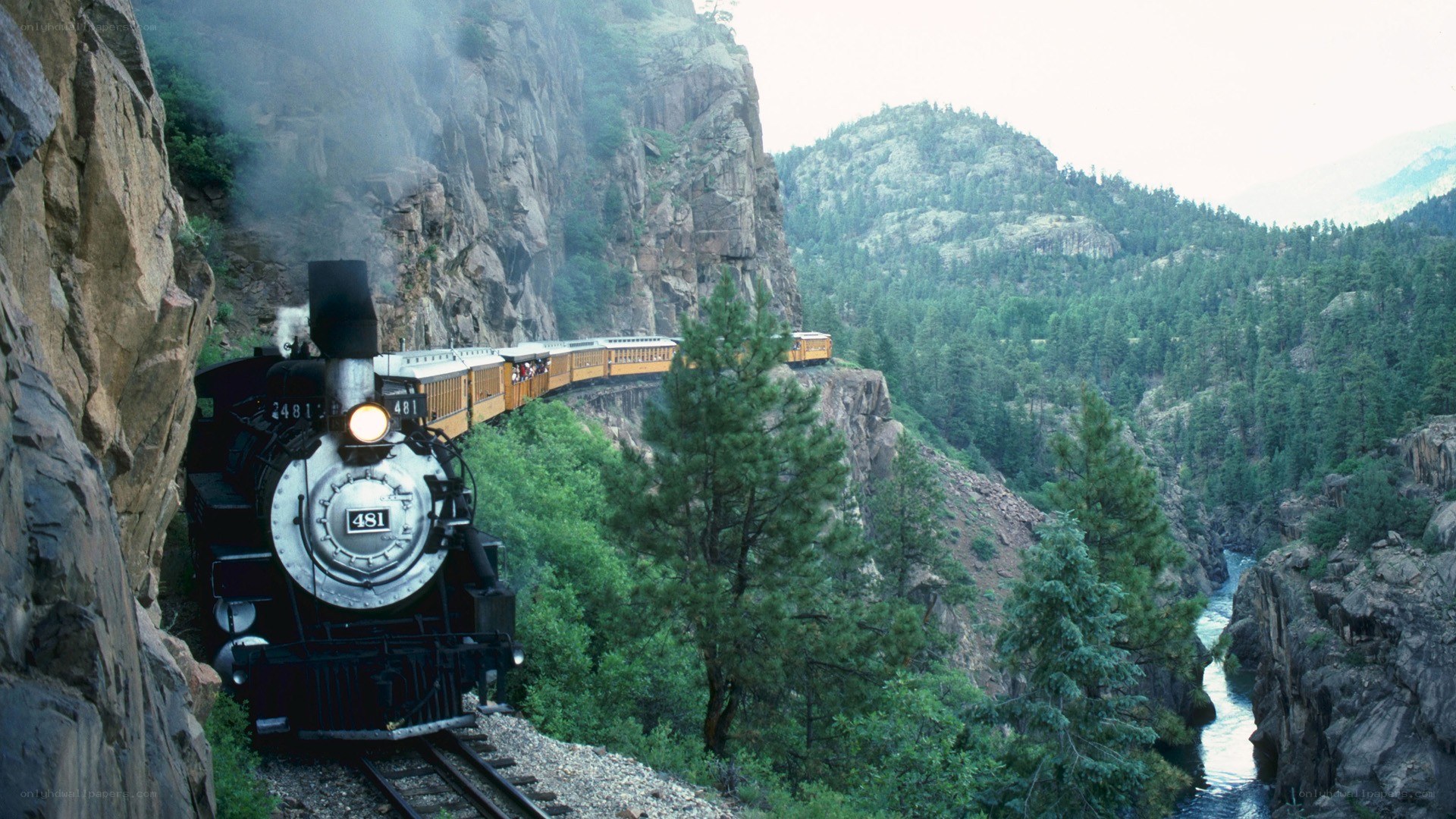 Steam train in mountain canyon
