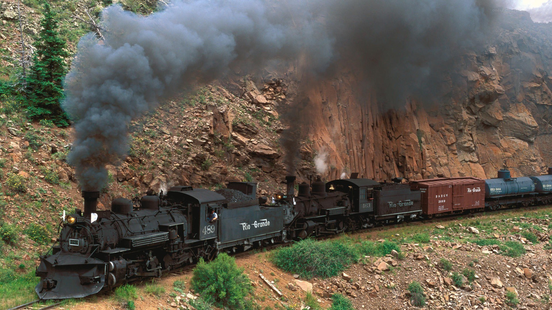 Steam train in mountain canyon