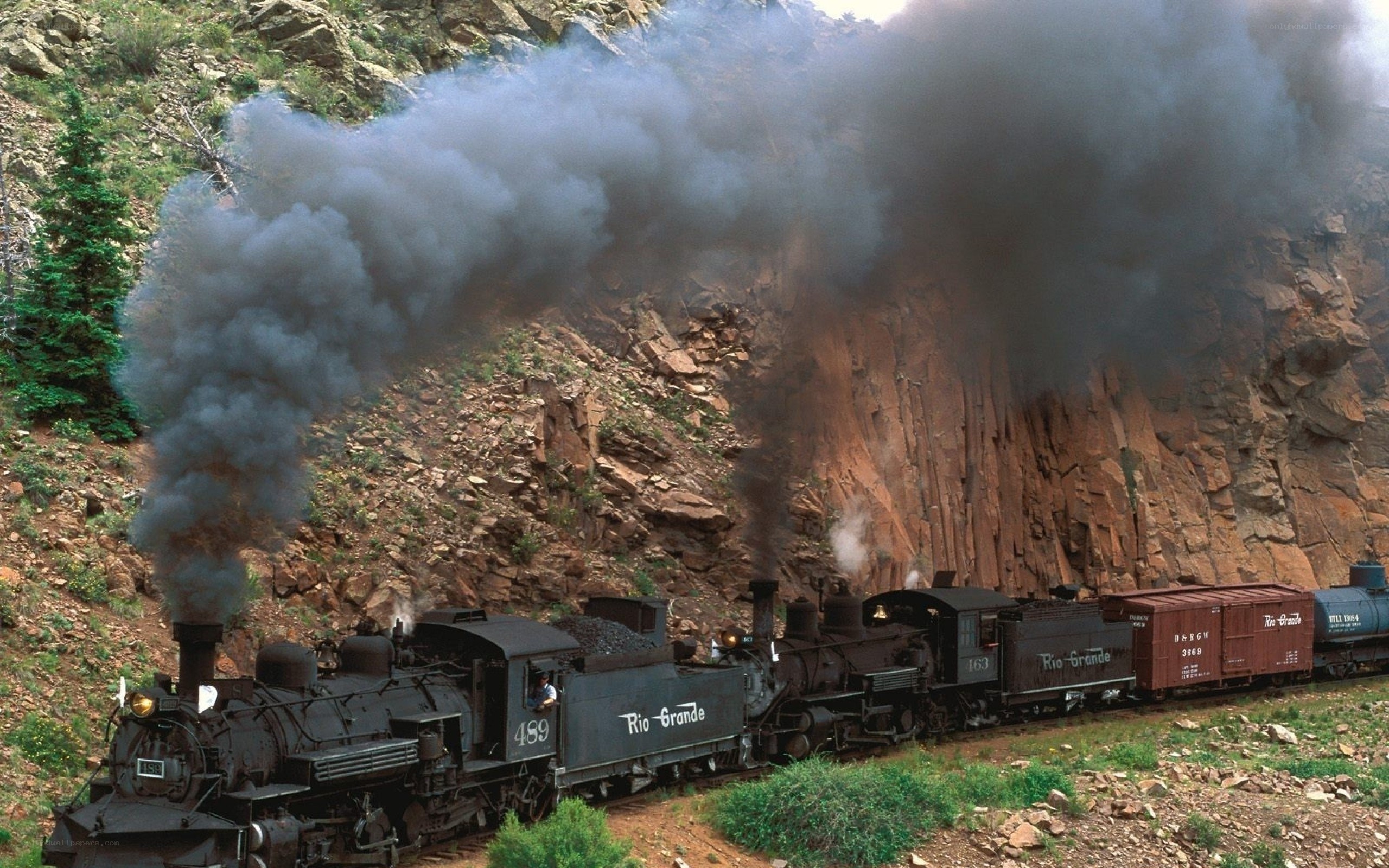 Steam train in mountain canyon
