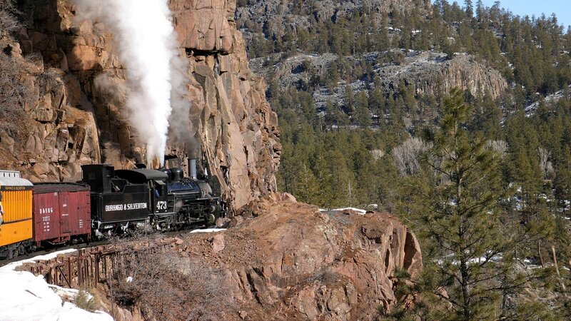 Steam train in mountain canyon