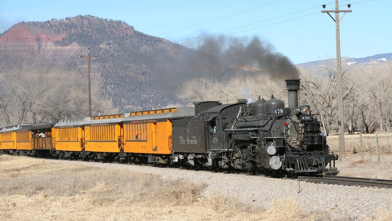 Steam train in mountain valley
