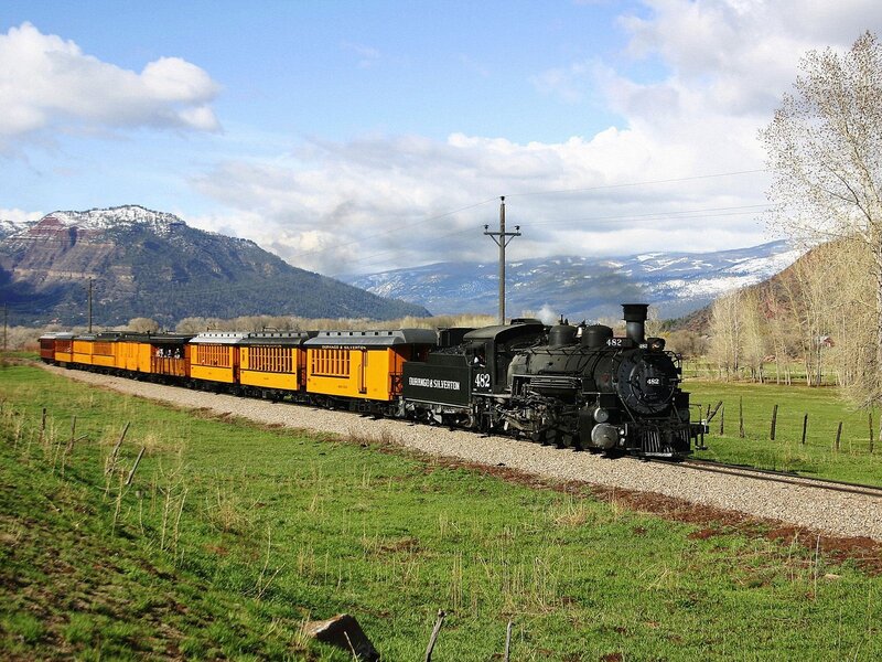 Steam train in mountain valley