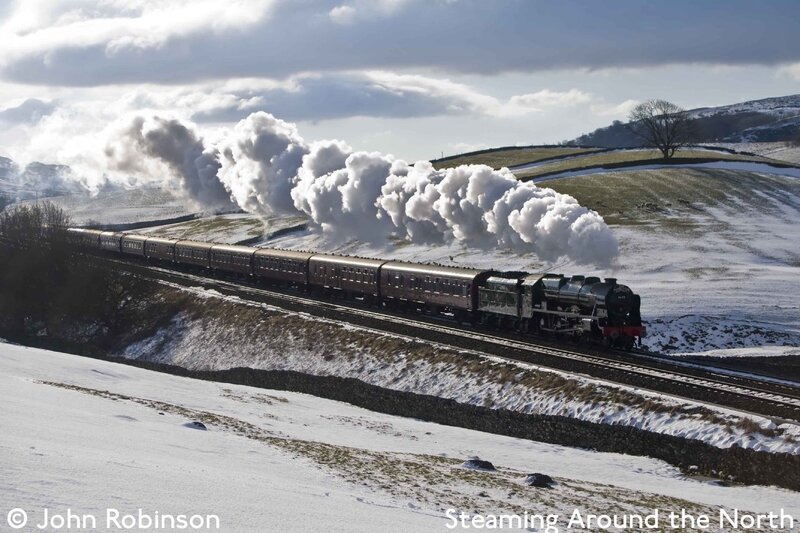 Steam train in snowy landscape