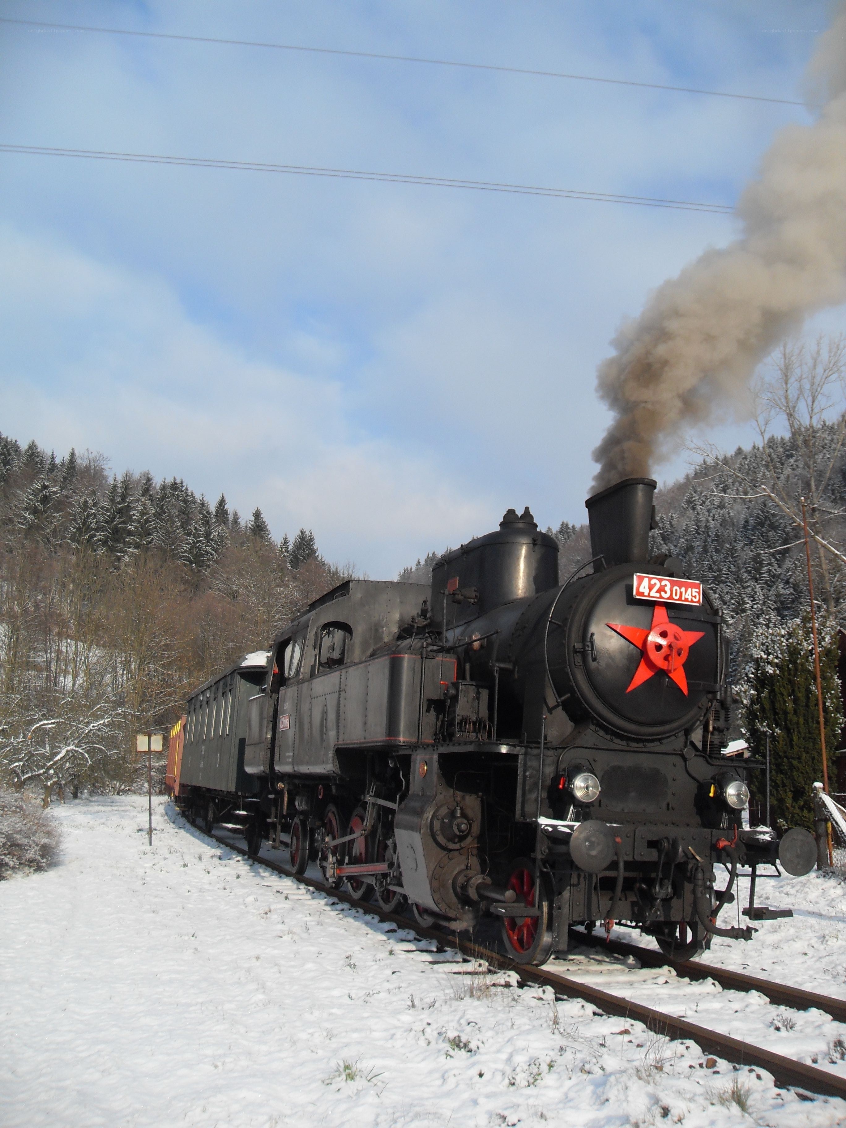 Steam train in snowy landscape