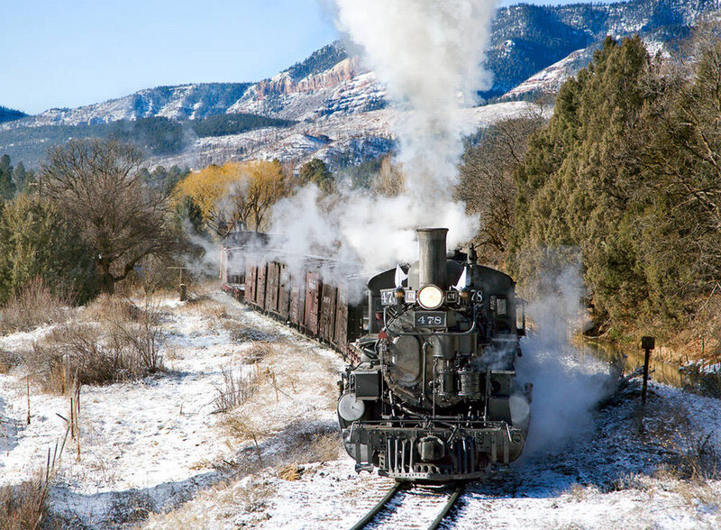 Steam train in snowy mountains