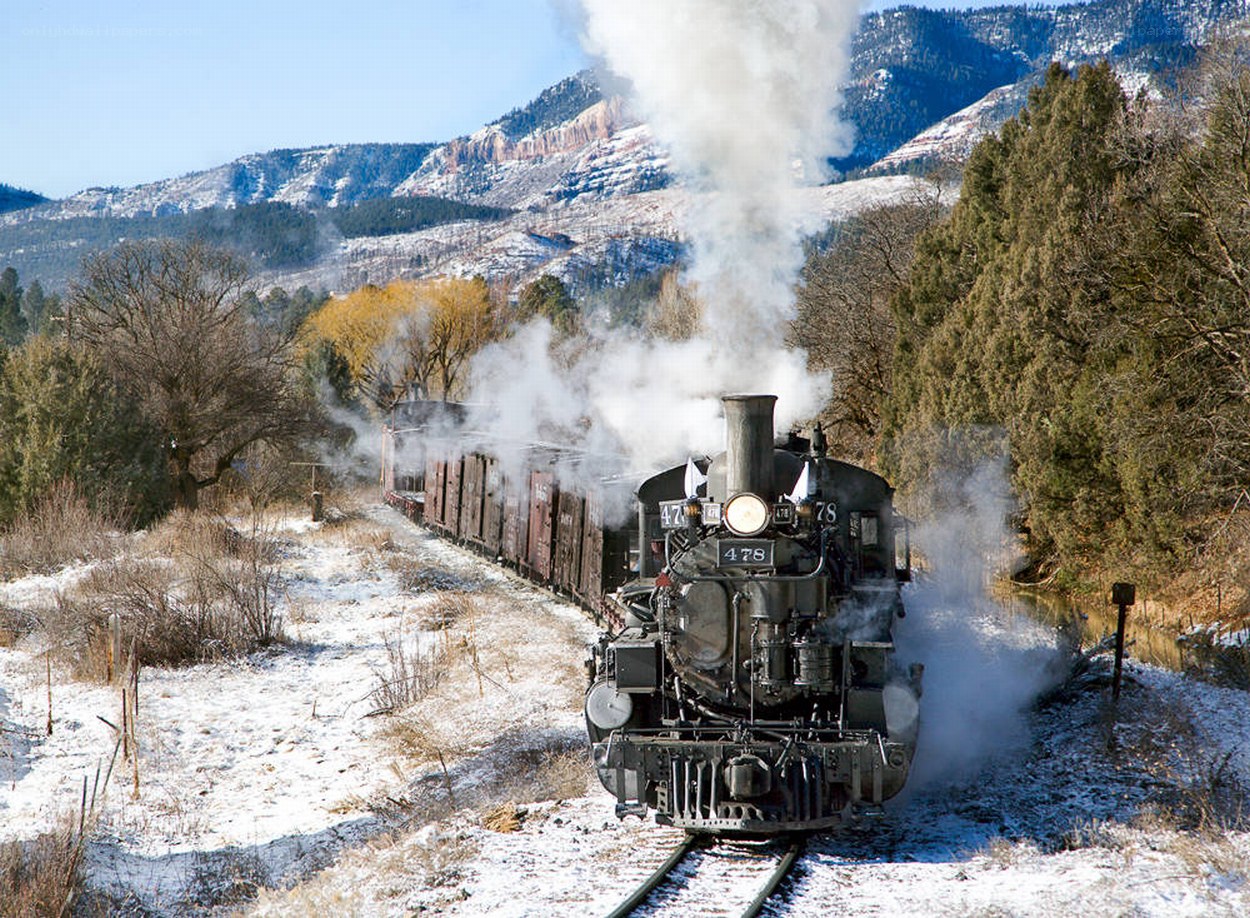 Steam train in snowy mountains