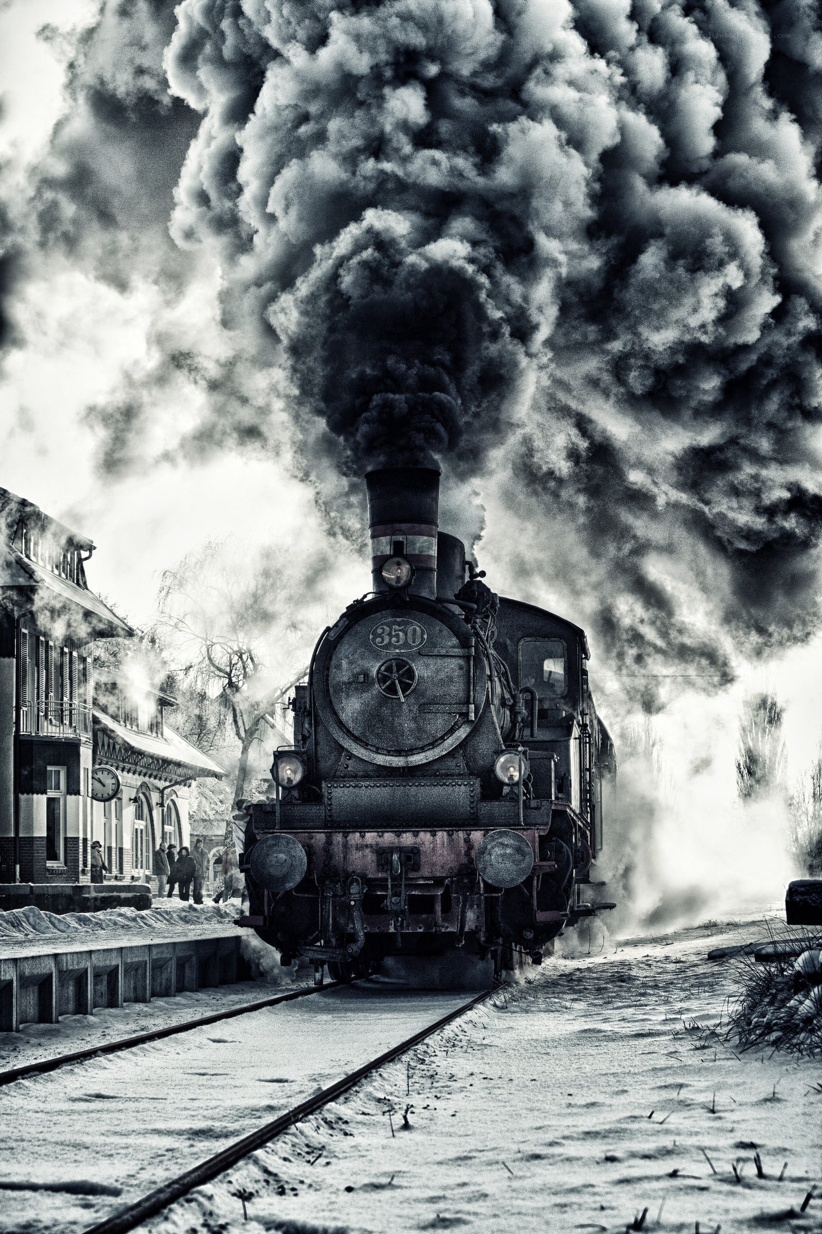 Steam train in snowy station
