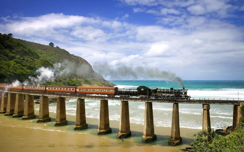 Steam Train on Bridge — Blue, Dramatic, Afternoon, Photograph, Ocean