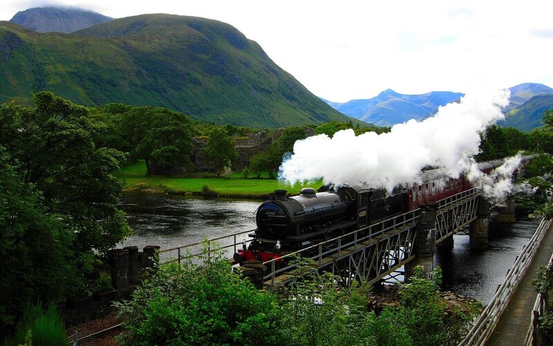 Steam Train on Bridge — Green, Serene, Afternoon, Photograph, River, Mountains, Trees, Black, White