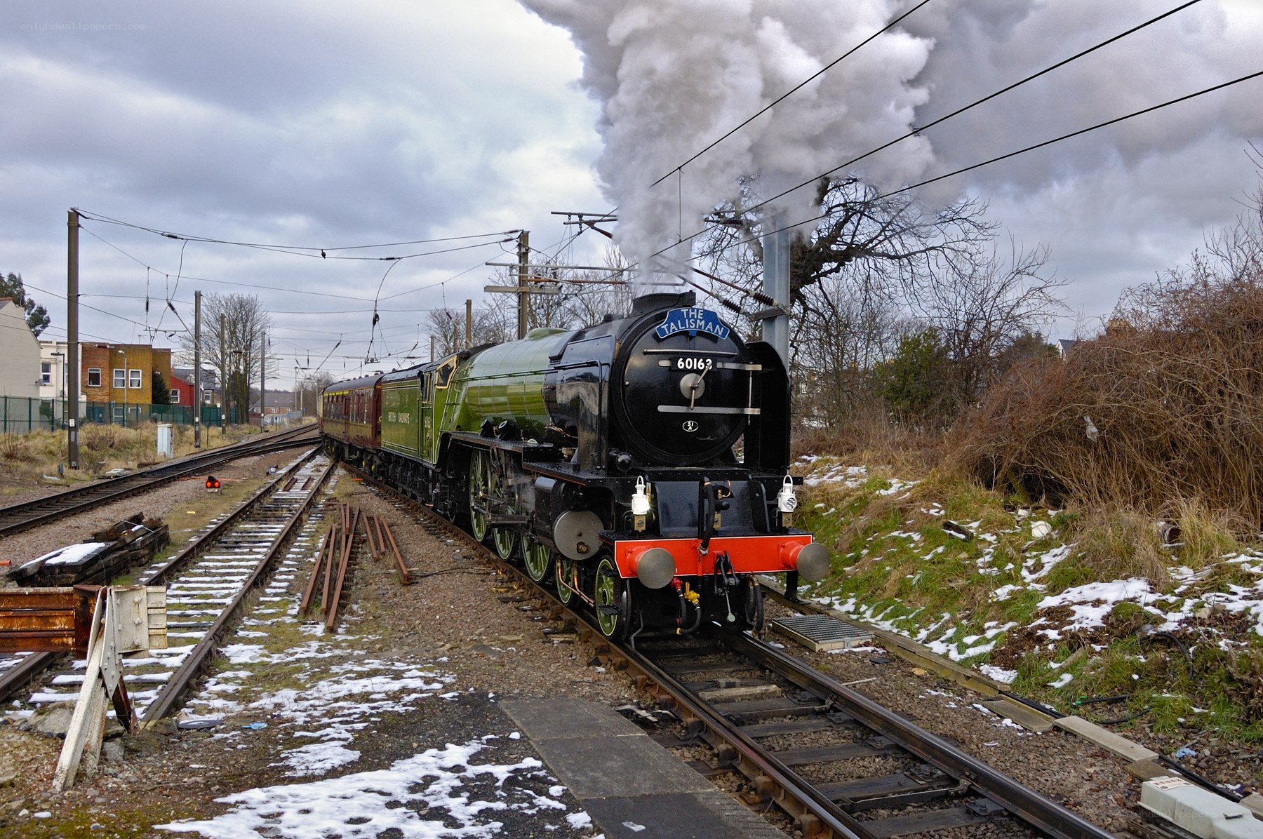 Steam train on snowy tracks