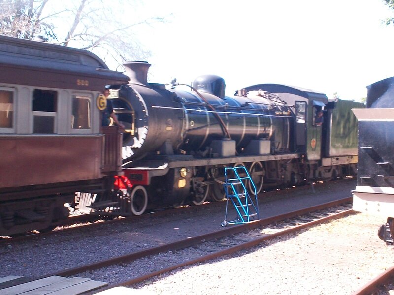 Steam Train on Tracks — Black, Calm, Afternoon
