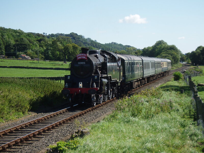 Steam Train on Tracks — Green, Serene, Afternoon, Photograph, Railway