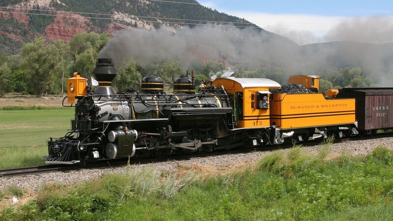 Steam Train on Tracks — Yellow, Active, Afternoon